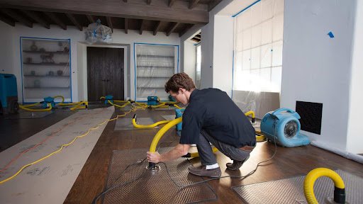 extracting water from a damaged floor by water damage restoration services las vegas